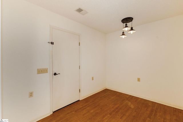 spare room featuring wood-type flooring