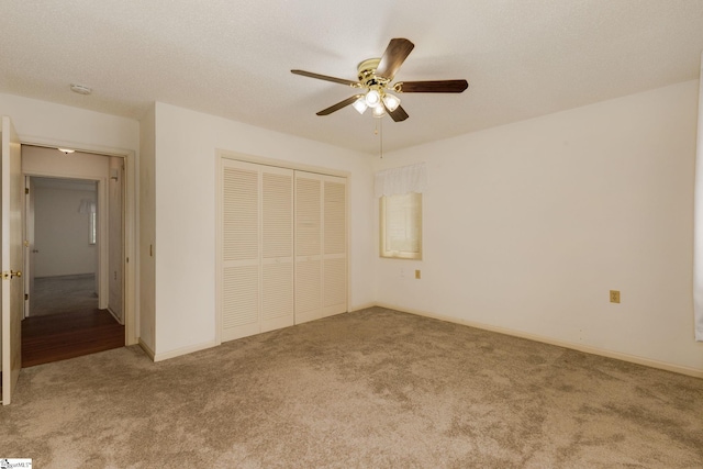 unfurnished bedroom with ceiling fan, a closet, and light carpet