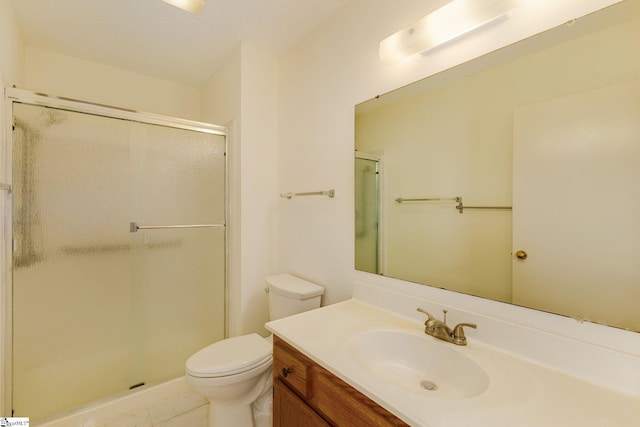 bathroom with tile patterned floors, toilet, vanity, and an enclosed shower