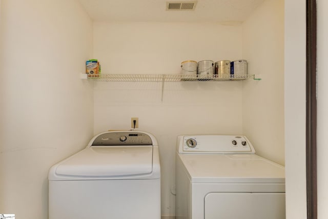 laundry area featuring washing machine and clothes dryer