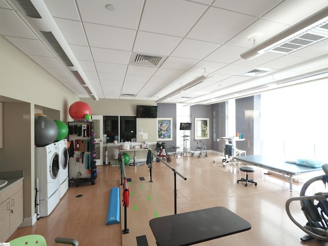 interior space with light wood-type flooring and washing machine and clothes dryer