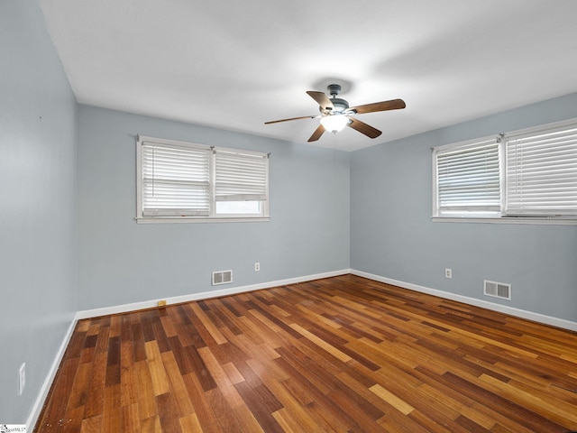 spare room featuring hardwood / wood-style floors and ceiling fan