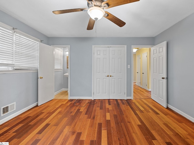 unfurnished bedroom with ceiling fan, light hardwood / wood-style floors, and ensuite bathroom