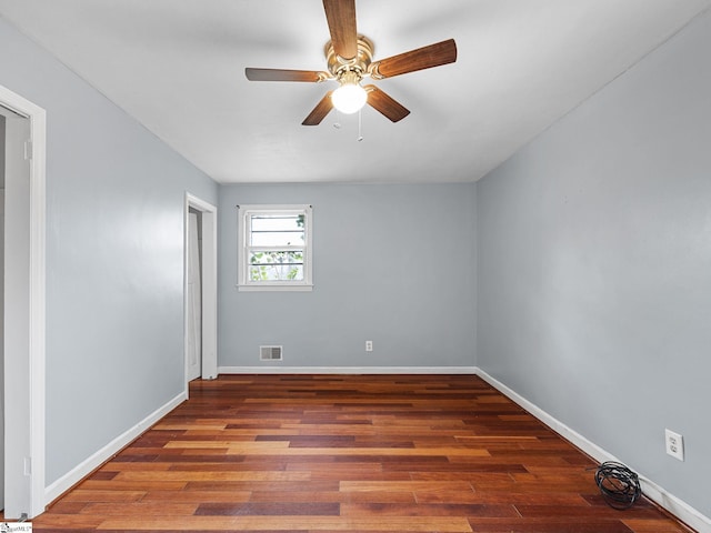 unfurnished room with ceiling fan and dark wood-type flooring