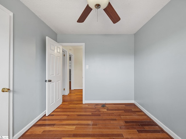 spare room with ceiling fan, wood-type flooring, and a textured ceiling