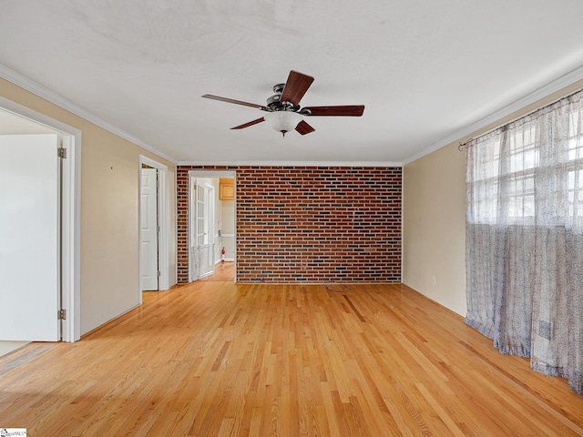 empty room with ceiling fan, crown molding, brick wall, and light hardwood / wood-style flooring