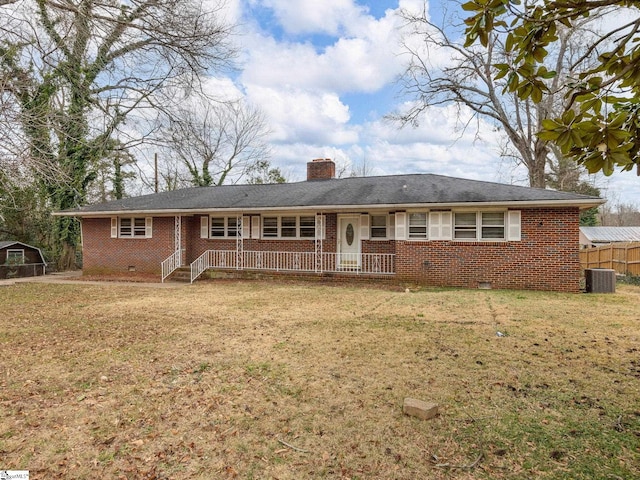 single story home with cooling unit and a front yard