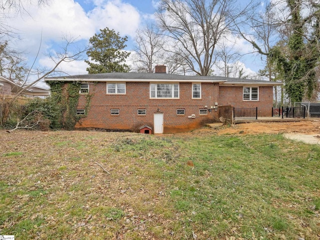 back of house with a lawn