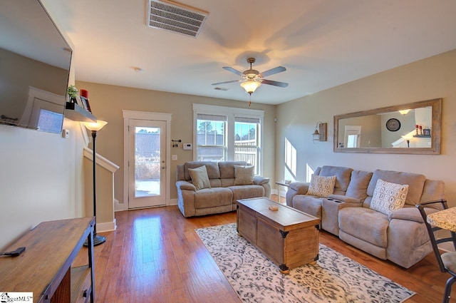 living room featuring ceiling fan and light hardwood / wood-style floors