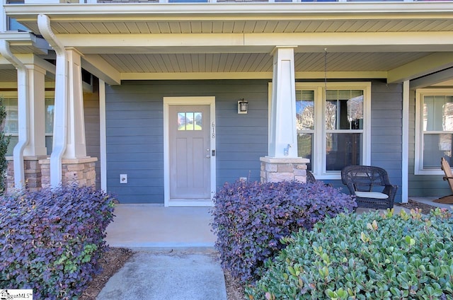 entrance to property featuring covered porch