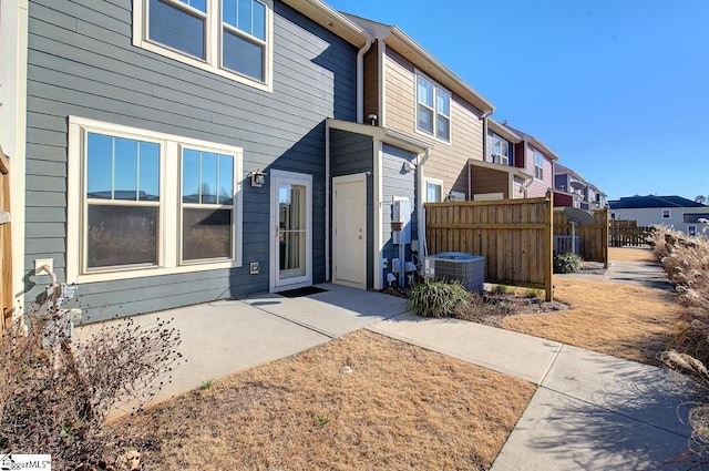 rear view of property featuring central AC unit and a patio area