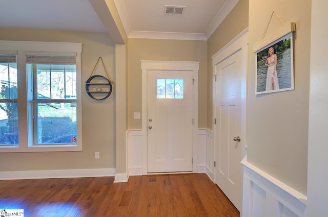 foyer featuring hardwood / wood-style floors and ornamental molding