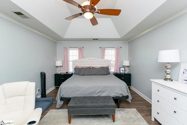 bedroom with dark hardwood / wood-style floors, a raised ceiling, ceiling fan, and crown molding