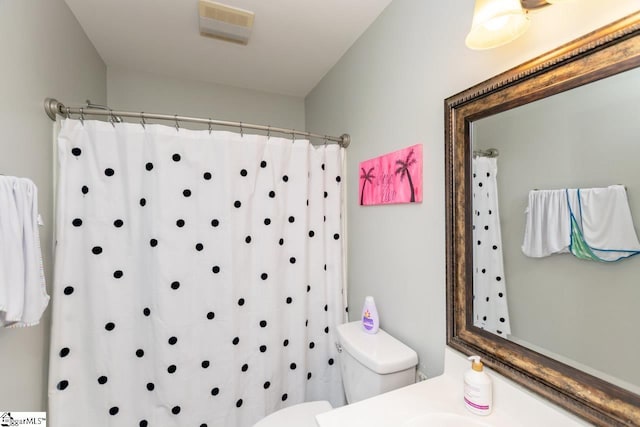 bathroom featuring vanity and toilet