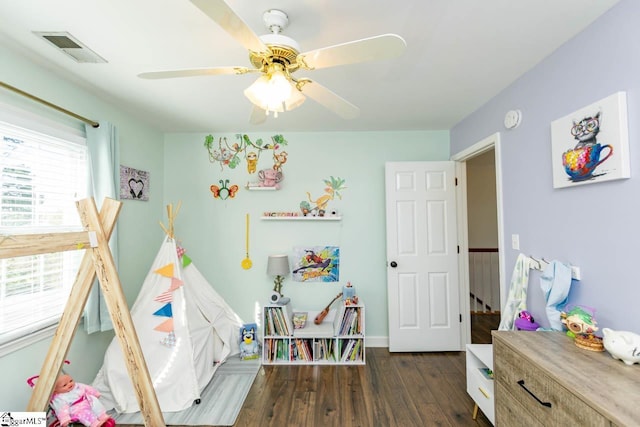 game room with ceiling fan and dark wood-type flooring