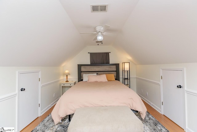 bedroom featuring ceiling fan, vaulted ceiling, and light hardwood / wood-style flooring