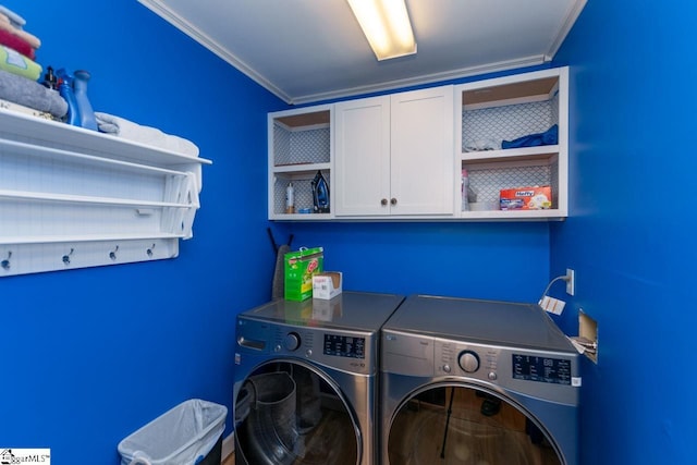 washroom featuring cabinets, separate washer and dryer, and ornamental molding