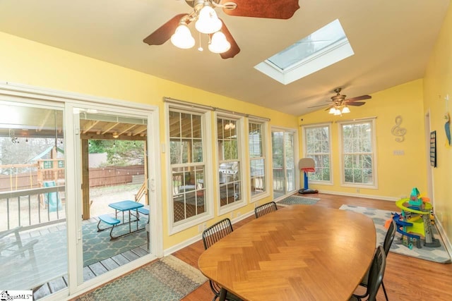 sunroom featuring ceiling fan and lofted ceiling with skylight