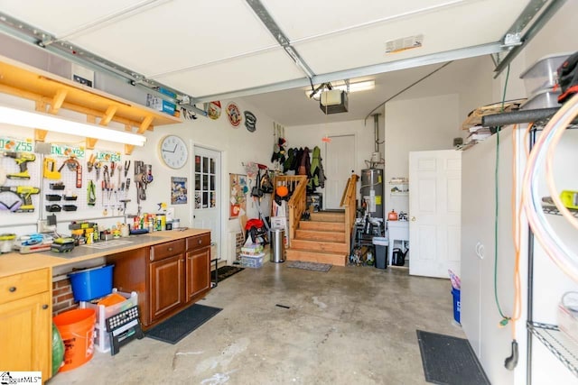 garage with a workshop area, gas water heater, and a garage door opener