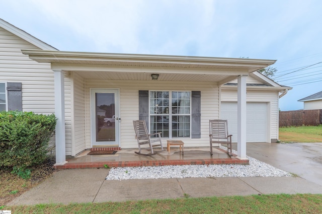 property entrance featuring covered porch and a garage