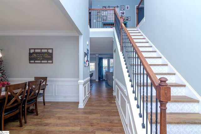 stairs featuring crown molding and hardwood / wood-style flooring