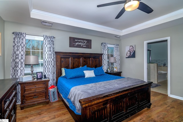 bedroom with ensuite bath, ceiling fan, hardwood / wood-style floors, and crown molding