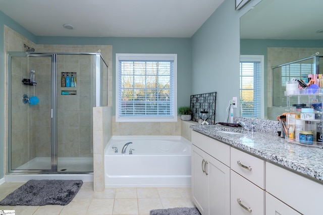 bathroom with plus walk in shower, tile patterned flooring, and vanity