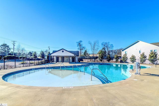 view of pool with an outbuilding and a patio area