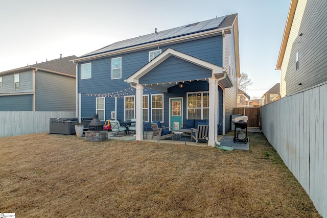 back of property featuring a lawn, outdoor lounge area, ceiling fan, a hot tub, and a patio