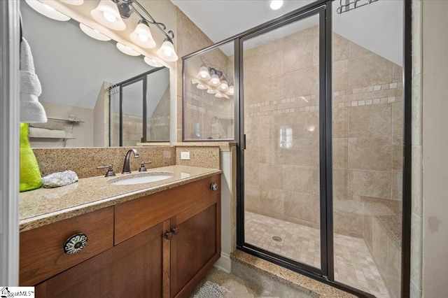 bathroom featuring vanity and a shower with door