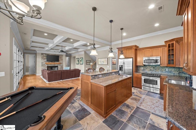 kitchen with sink, hanging light fixtures, stainless steel appliances, coffered ceiling, and beamed ceiling