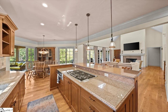 kitchen featuring a kitchen island, pendant lighting, and stainless steel gas cooktop