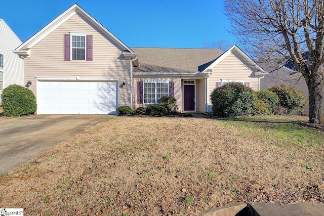 view of front of house with a front yard and a garage