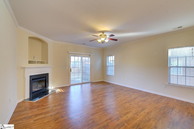 unfurnished living room with hardwood / wood-style floors, ceiling fan, and crown molding