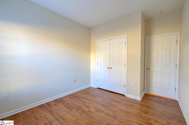 unfurnished bedroom with hardwood / wood-style flooring