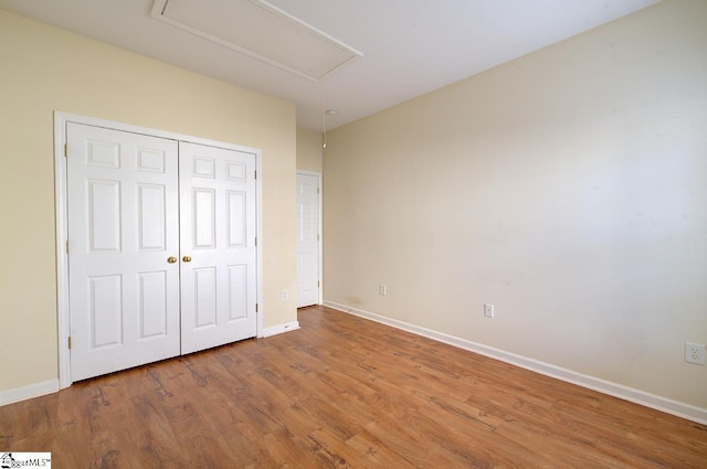 unfurnished bedroom with hardwood / wood-style floors and a closet