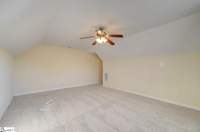 additional living space with light colored carpet, vaulted ceiling, and ceiling fan