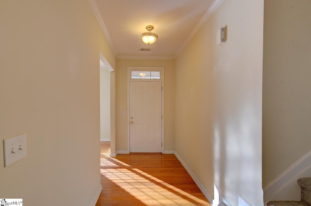 doorway featuring hardwood / wood-style flooring and ornamental molding