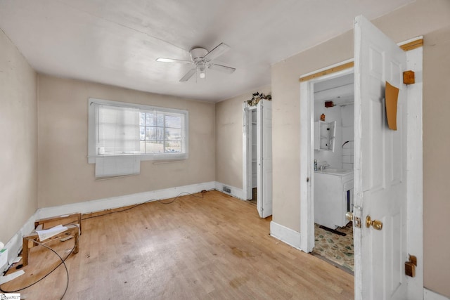 unfurnished bedroom featuring ceiling fan, light hardwood / wood-style floors, sink, and connected bathroom