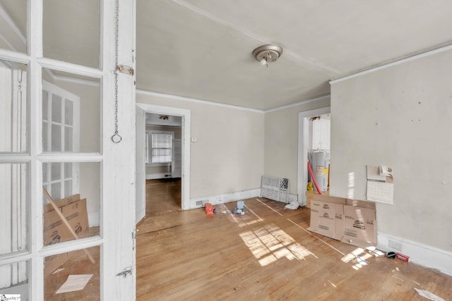 interior space featuring electric water heater and light wood-type flooring