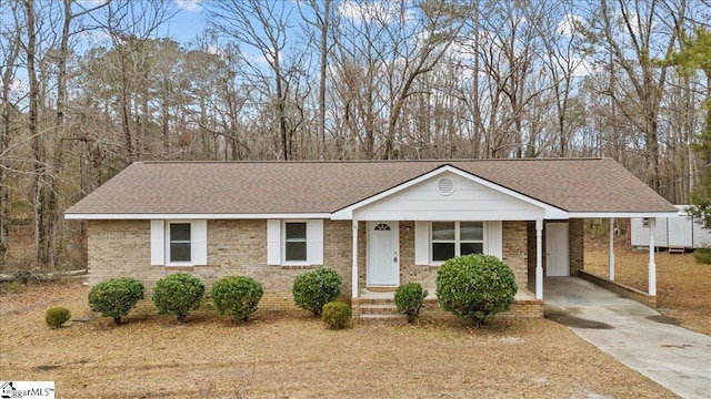 view of front of home with a porch and a carport