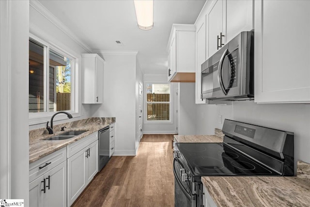 kitchen featuring black range oven, dishwasher, white cabinetry, and sink