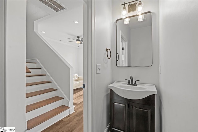 bathroom with ceiling fan, vanity, and hardwood / wood-style flooring