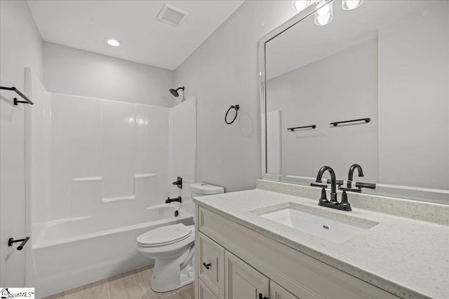 full bathroom with vanity, toilet, shower / bathing tub combination, and hardwood / wood-style flooring