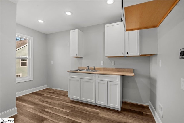 kitchen featuring white cabinets, hardwood / wood-style floors, and sink