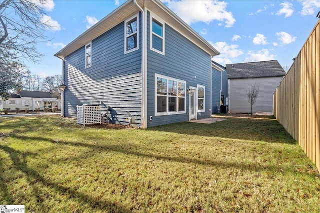 rear view of property with a lawn