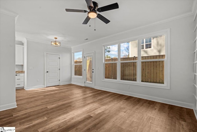 interior space featuring ceiling fan with notable chandelier, light hardwood / wood-style floors, and crown molding