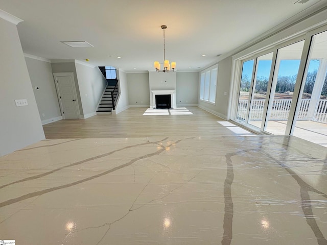 unfurnished living room with a notable chandelier and crown molding