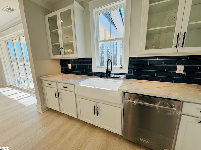 kitchen with dishwasher, sink, light hardwood / wood-style flooring, light stone countertops, and white cabinetry