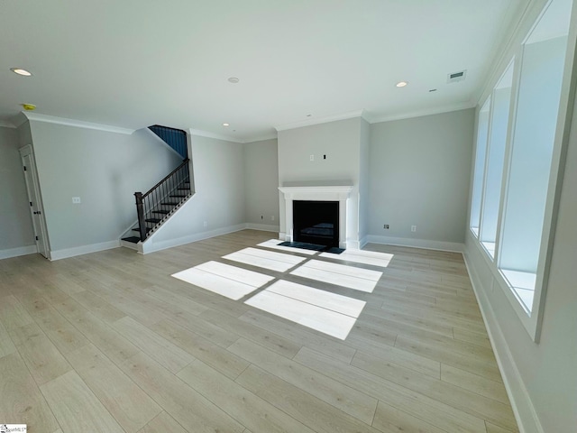 unfurnished living room with light hardwood / wood-style flooring and ornamental molding